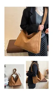 Detailed view of brown suede tote bag with stylish scrunchie shoulder strap design