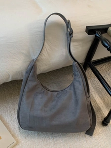 Dark grey faux suede hobo bag with adjustable strap and silver metal hardware