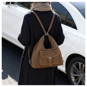 Detailed back view of a dark brown multi-functional backpack with sleek metal buckle detail