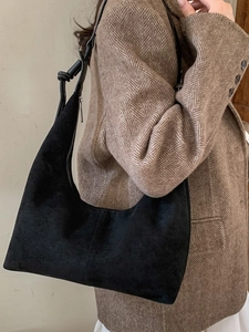 Retro black suede hobo shoulder bag with crescent shape and knotted strap details