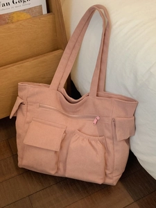 Pink corduroy multi-pocket tote bag with a minimalist design and top zip closure