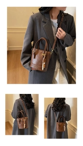 Detail of dark brown retro PU leather bucket bag with fashion logo and beaded charm