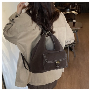 Detail of vintage dark brown faux suede bag with white contrast stitching and buckle