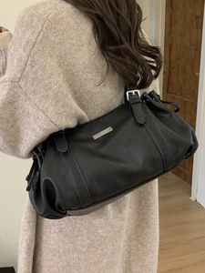Chic black pebble leather underarm bag with drawstring details and adjustable strap