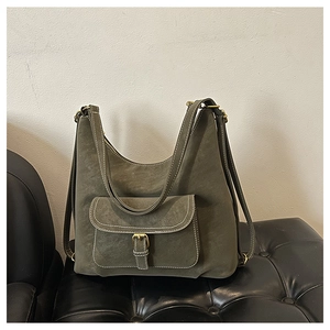Detail of olive green multi-functional bag with gold buckle and white contrast stitching