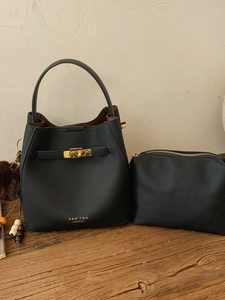 Sac à main seau en cuir noir grainé avec détails dorés et accessoire charm en peluche
