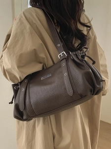 Deep brown pebbled leather shoulder bag with buckle straps and retro cargo design