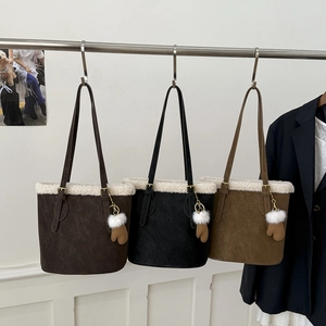 Lambswool trim suede bucket bags in dark brown, black, and khaki with glove charms