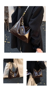 Close-up of a vintage brown glossy leather hobo bag with a matching small coin purse