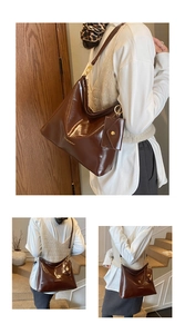 Detail of dark brown glossy patent leather tote with gold hardware and mini charm bag