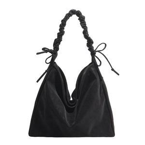Chic black velvet tote bag with ruffled cloud handle and delicate bow accents