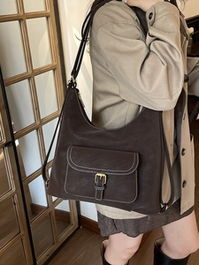 Large dark brown leather hobo bag with contrast stitching and golden buckle strap