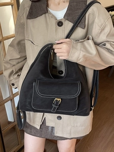 Versatile black hobo bag with white contrast stitching and adjustable shoulder strap