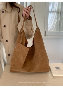 Close-up of brown suede tote bag featuring a minimalist retro hobo design and a small pouch