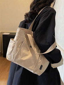 Minimalist beige waterproof nylon tote bag with large capacity and versatile shoulder straps