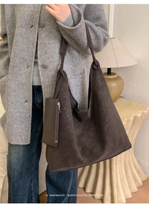 Detail of dark brown hobo shoulder bag with a matte texture and detachable pouch