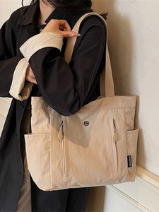 Waterproof nylon tote bag for women in cream beige, spacious and minimalist for daily commute