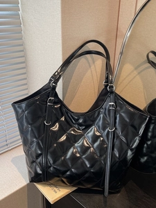 Classic black quilted leather tote bag with silver buckle details and large capacity