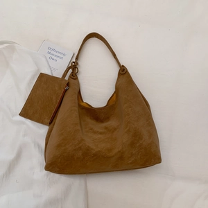 Macro shot of caramel hobo bag with a matching detachable zipper coin purse