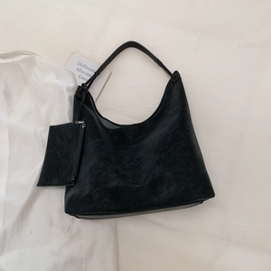 Detail of black faux suede tote bag with a matching small detachable zipper pouch