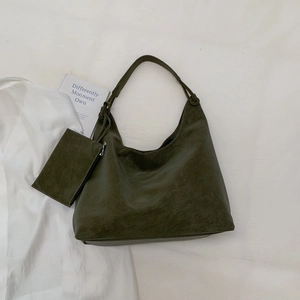 Overhead view of olive green leather hobo tote bag with a matching zippered inner pouch