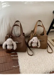 Litchi pattern bucket bags in brown and caramel leather with cute rabbit charms