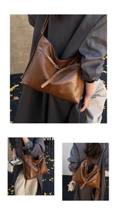 Detail of a large brown leather tote bag with white contrast stitching and metal buckle