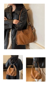Detail of vintage brown leather backpack with teddy bear charm and fashion logo stamp