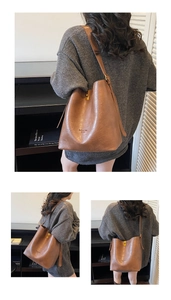 Detail of vintage brown suede tote bag with adjustable strap and fashion bag engraving