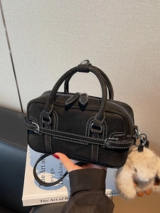 Chic black matte Boston handbag with contrast white stitching and cute rabbit charm