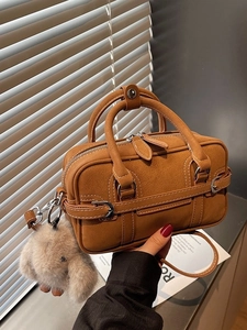 Retro caramel brown leather tote bag with grainy texture and cute bunny charm accessory