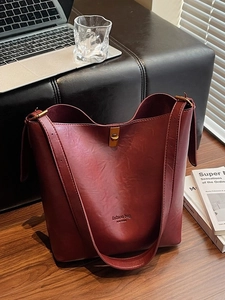 Retro burgundy bucket bag with gold buckle and adjustable strap for commuting