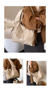 Detail of the minimalist tote bag with metal logo plate and smooth matte texture