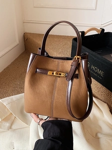 Brown suede-texture bucket bag with top handle and gold C-buckle closure for women
