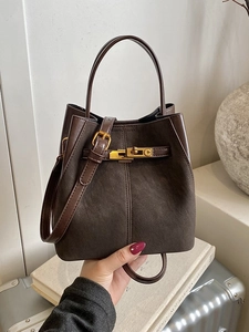 Chic dark brown suede bucket bag with gold hardware and adjustable strap for women