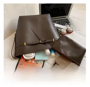 Deep brown bucket bag showing large internal capacity with tablet and daily essentials