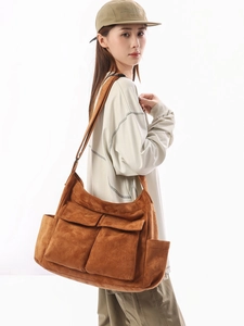 Brown vintage canvas shoulder bag with large flap pockets in a minimalist workwear style