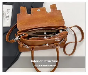 Detailed interior view showing main, zipper, phone, and front pockets of the brown bag