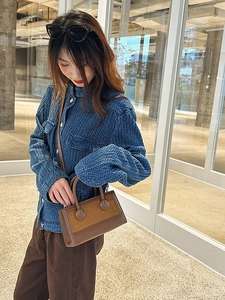 Vintage brown leather crossbody handbag for women styled with casual winter outfit