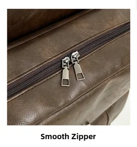 Close-up of smooth metal double zippers on a dark brown leather fashion backpack