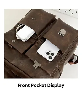 Close-up of brown vintage leather backpack front pockets showing mobile phone storage