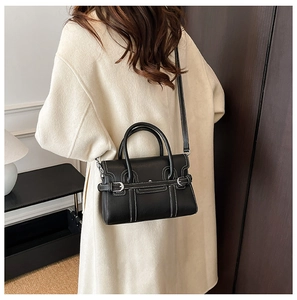 Detail showing high-quality black PU leather texture with contrast stitching and silver buckle