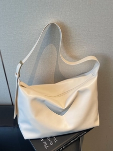 Minimalist large capacity cream leather tote bag with soft hobo silhouette and top zipper