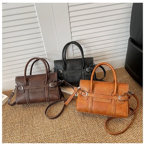 Detailed display of vintage-style handbags in brown, black, and tan with leather textures