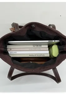 Interior view of deep brown suede tote bag showing large capacity and zipper pocket