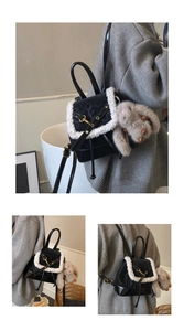 Detail of black suede mini backpack with leopard flap, plush trim, and grey bunny charm