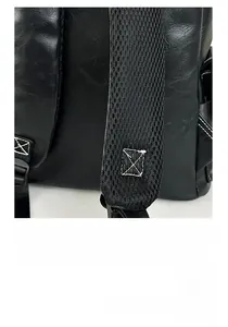 Detail of widened ergonomic S-shaped shoulder straps with breathable mesh on black backpack