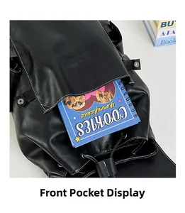 Detail of front pocket on black vintage backpack with contrast stitching and metal snap