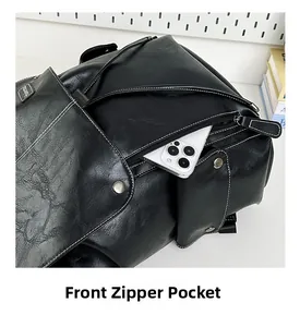 Detailed macro view of the front zipper pocket on a black pebble leather backpack