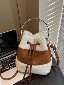 Plush faux fur bucket bag with leather patchwork and silver ring handle for winter